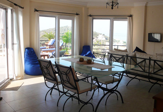 Contemporary dining and lounge space with sea views from all windows